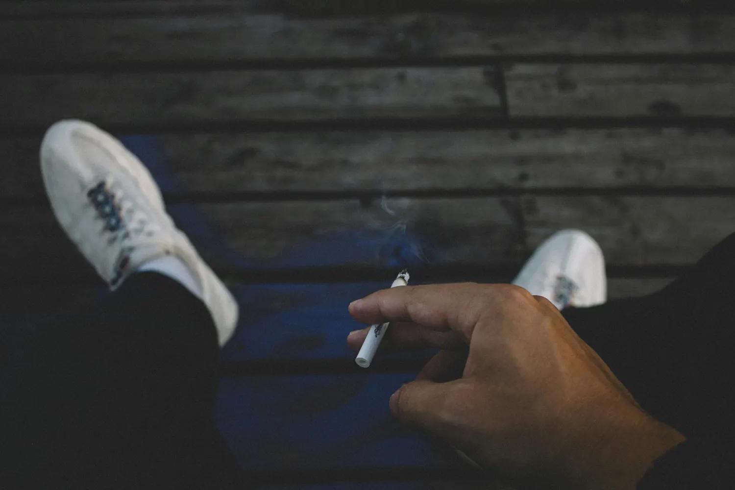 person holding a cigarette smoking
