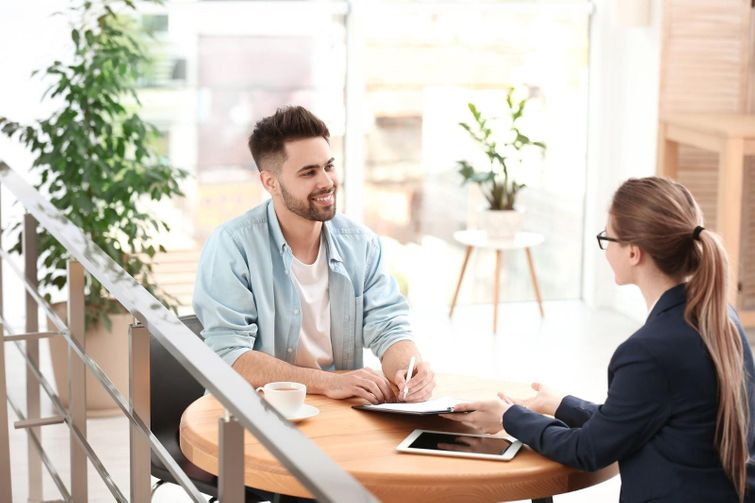 woman in suit discussing life insurance with a man