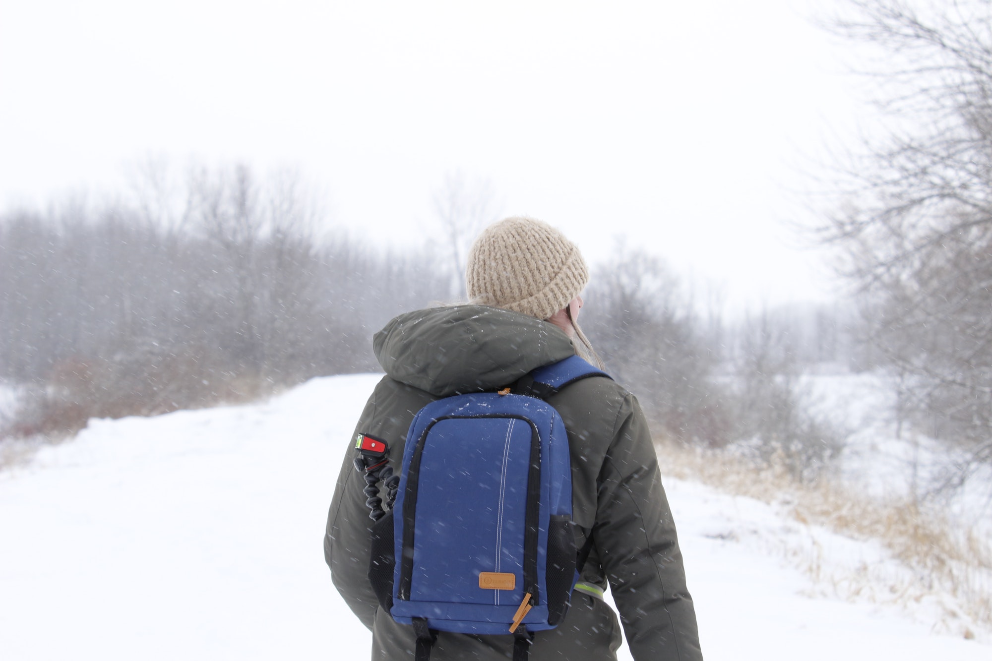 Caucasian (White) female standing in a snow-capped forest in Canada