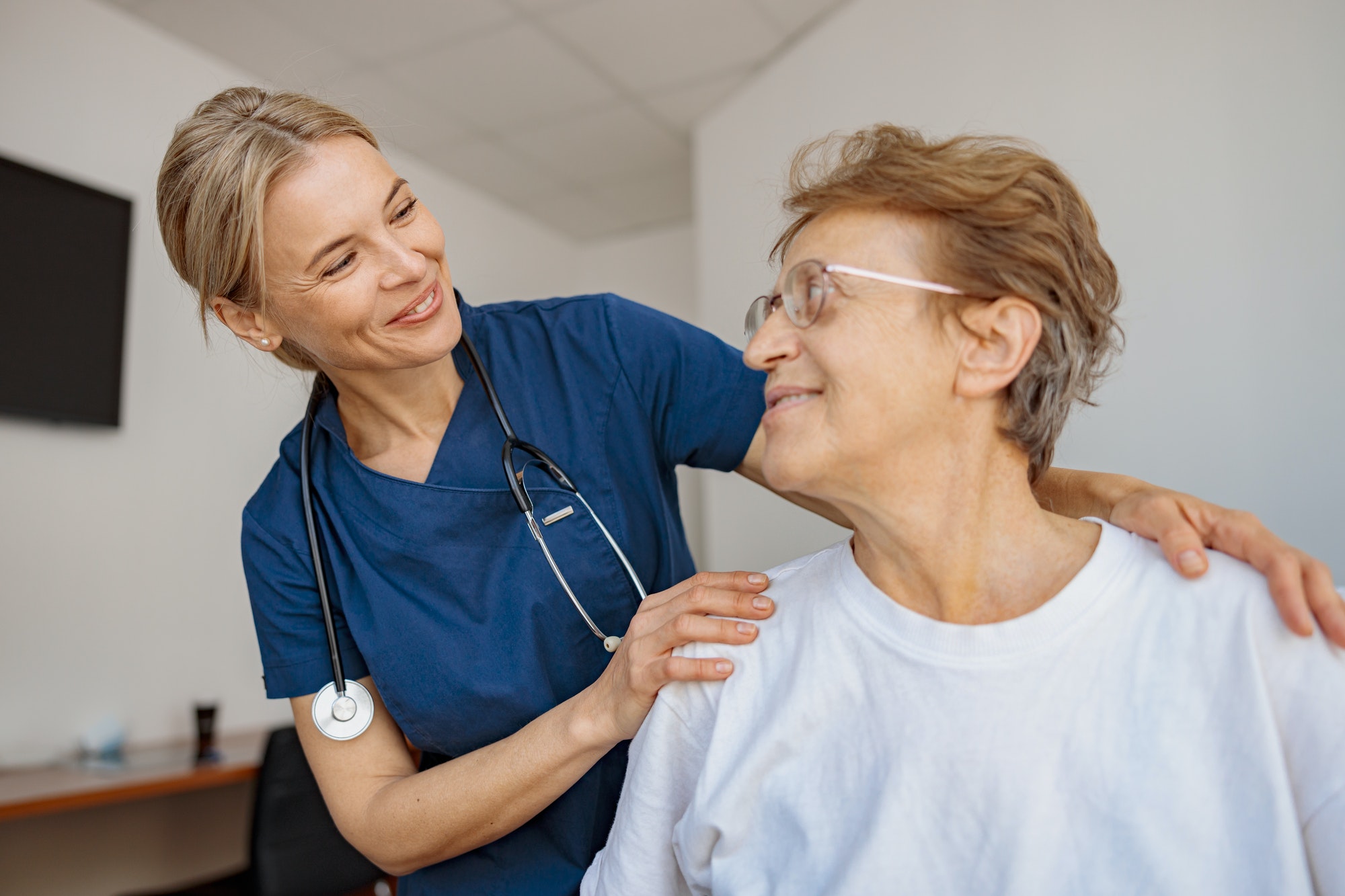 Doctor supporting a sick patient before medical procedures in a hospital room