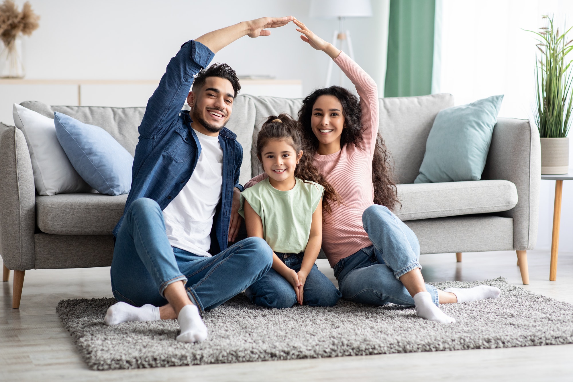 Family Protection. Mom And Dad Making Roof Of Hands Above Their Daughter