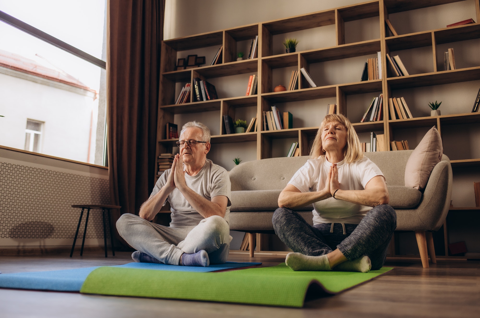 Old elderly senior grandparents spouses couple husband and wife doing sports activity