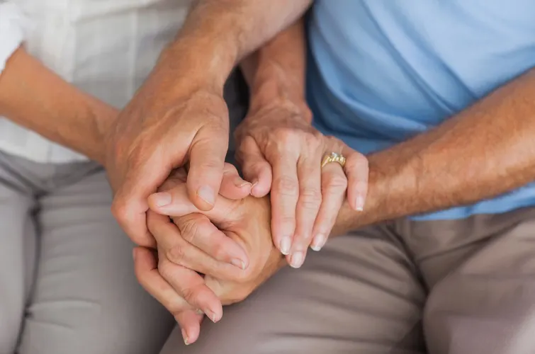 aging couple holding hands