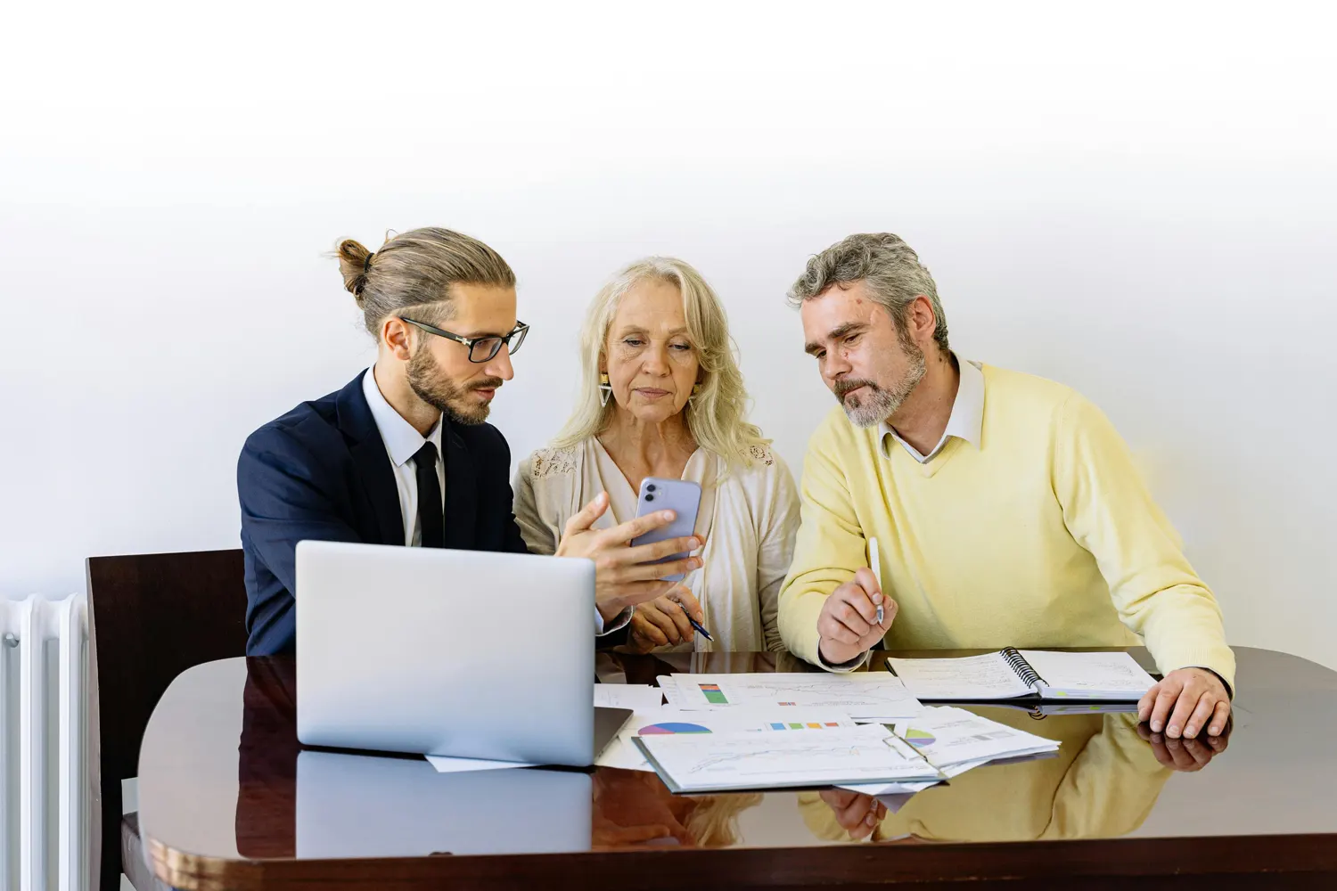 people looking over insurance papers with broker