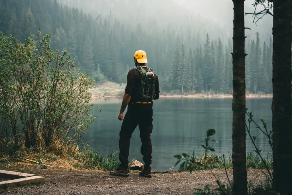 Man looking out at a lake in rural Alberta Canada