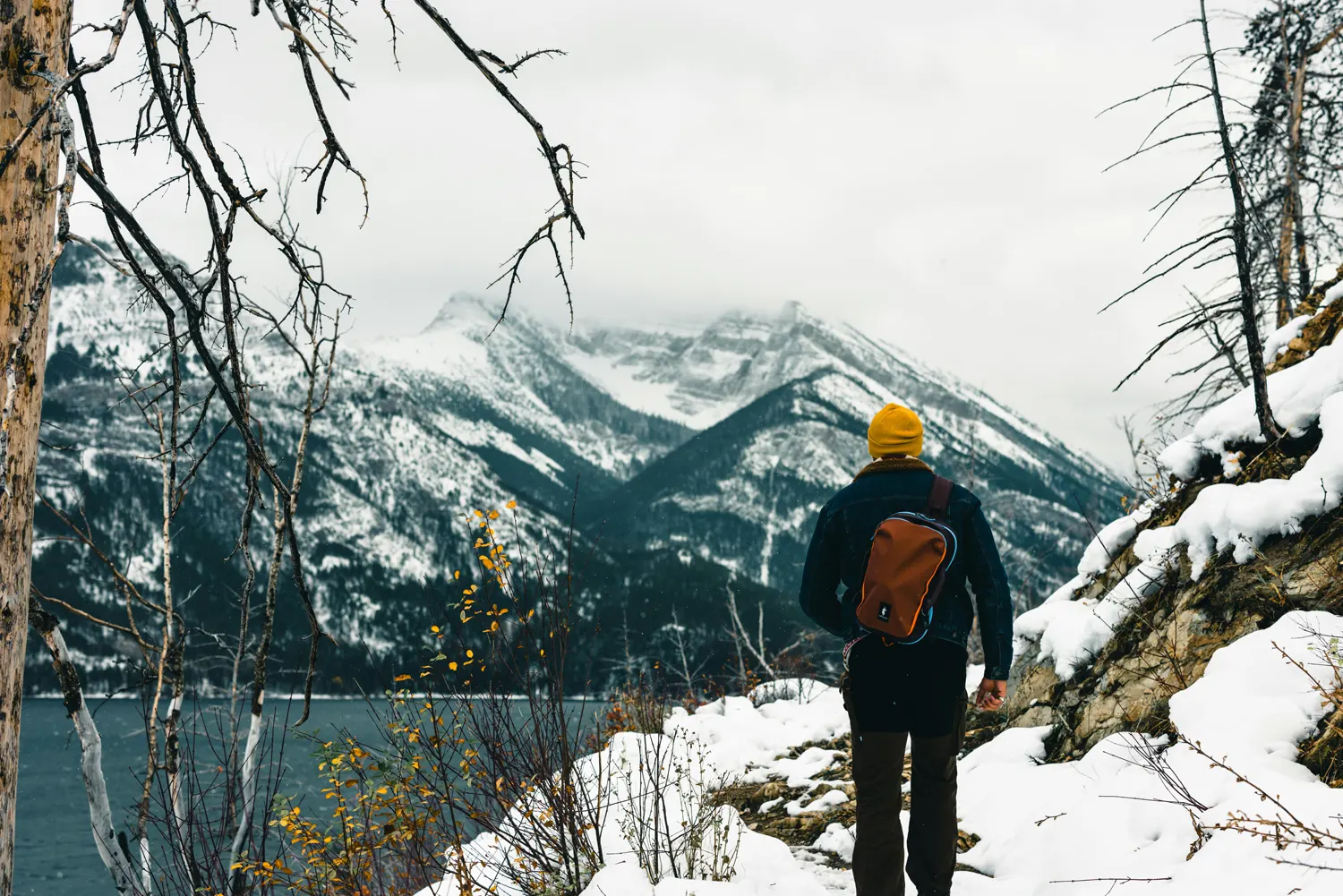 Man looking out at a lake in rural Alberta Canada