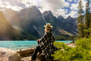 person sitting on a lake in the Rockies