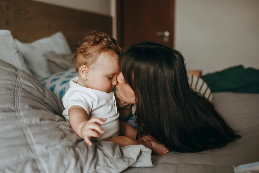 mom kissing new baby